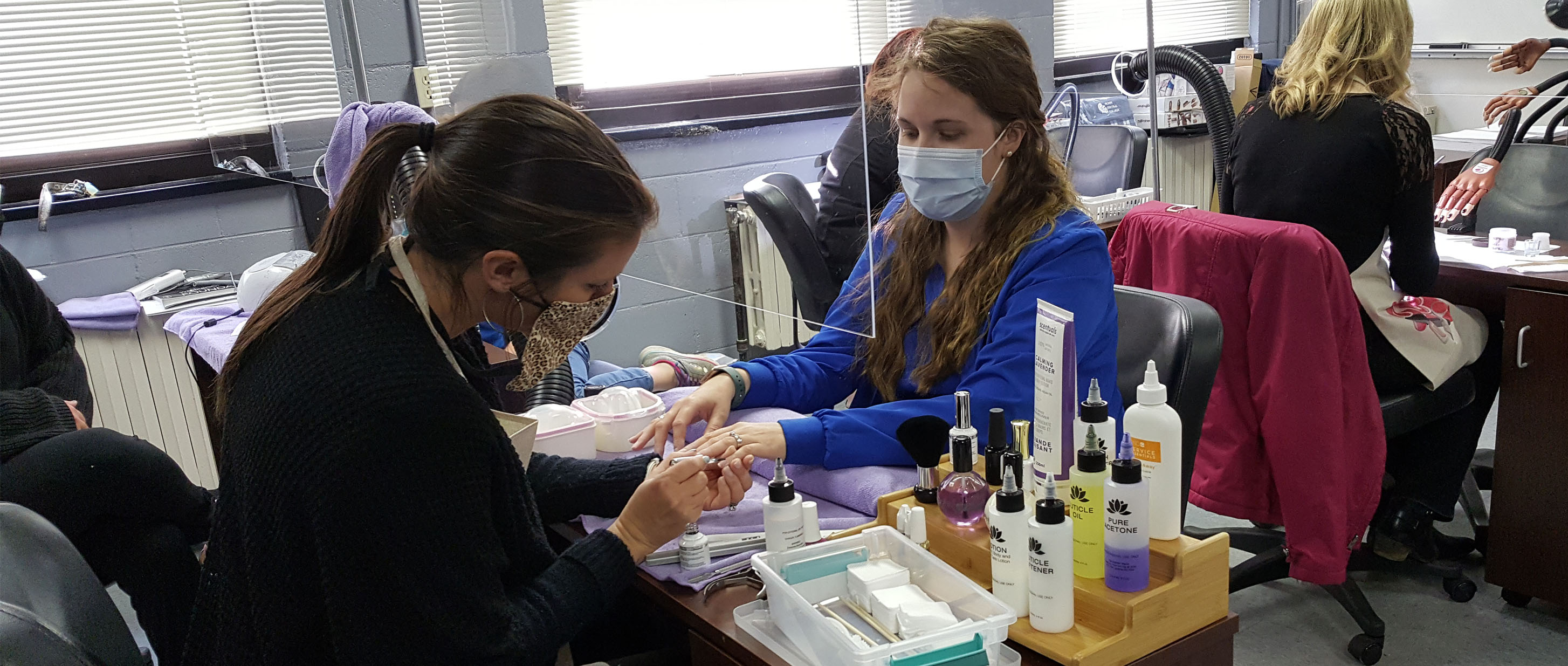 Photo of Student Giving a Client a Manicure