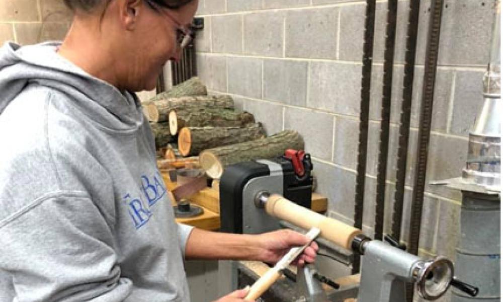 Photo of Student utilizing equipment in the Woodworking class