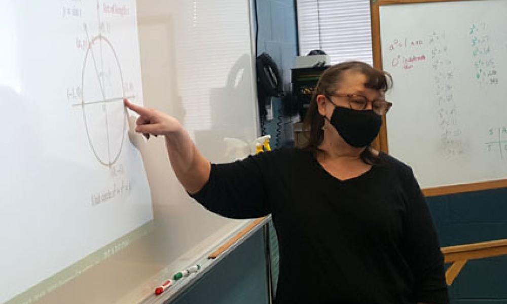 Photo of Instructor Lisa Benson at the white board