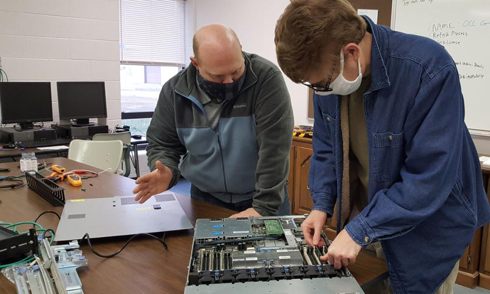 Instructor and student working on computer