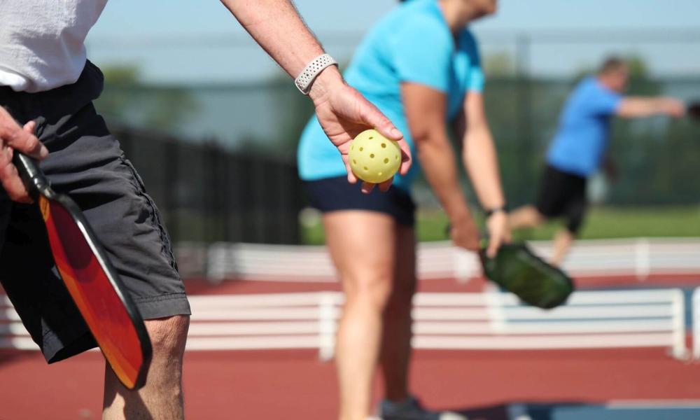 Two People standing on a pickleball court