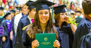 Graduate showing off her diploma