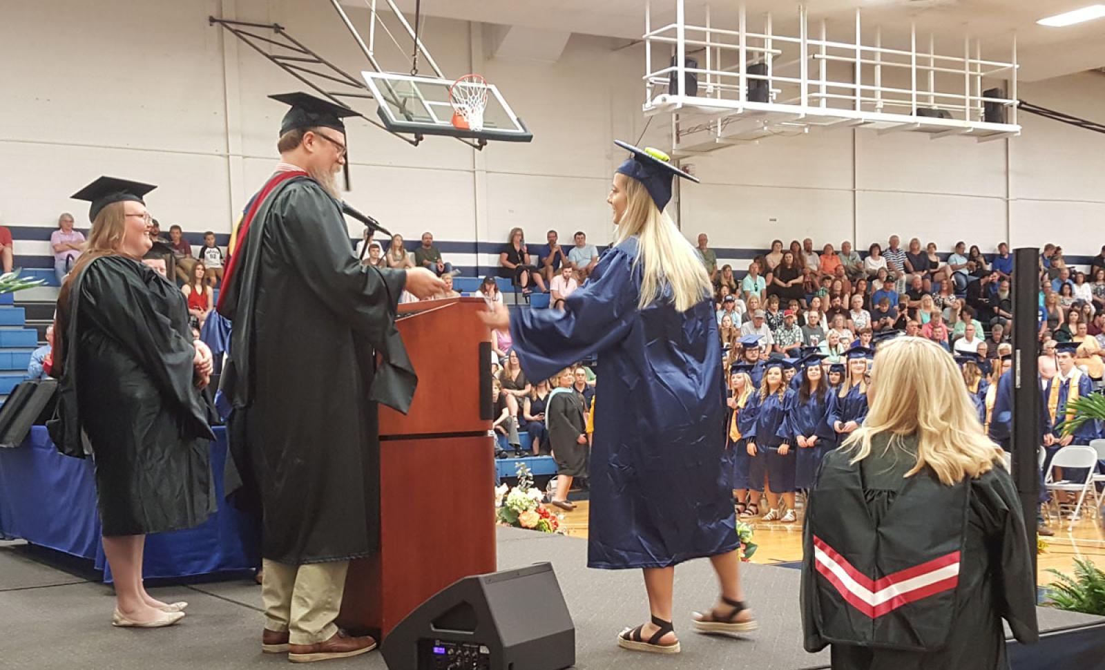 Photo of graduate receiving diploma