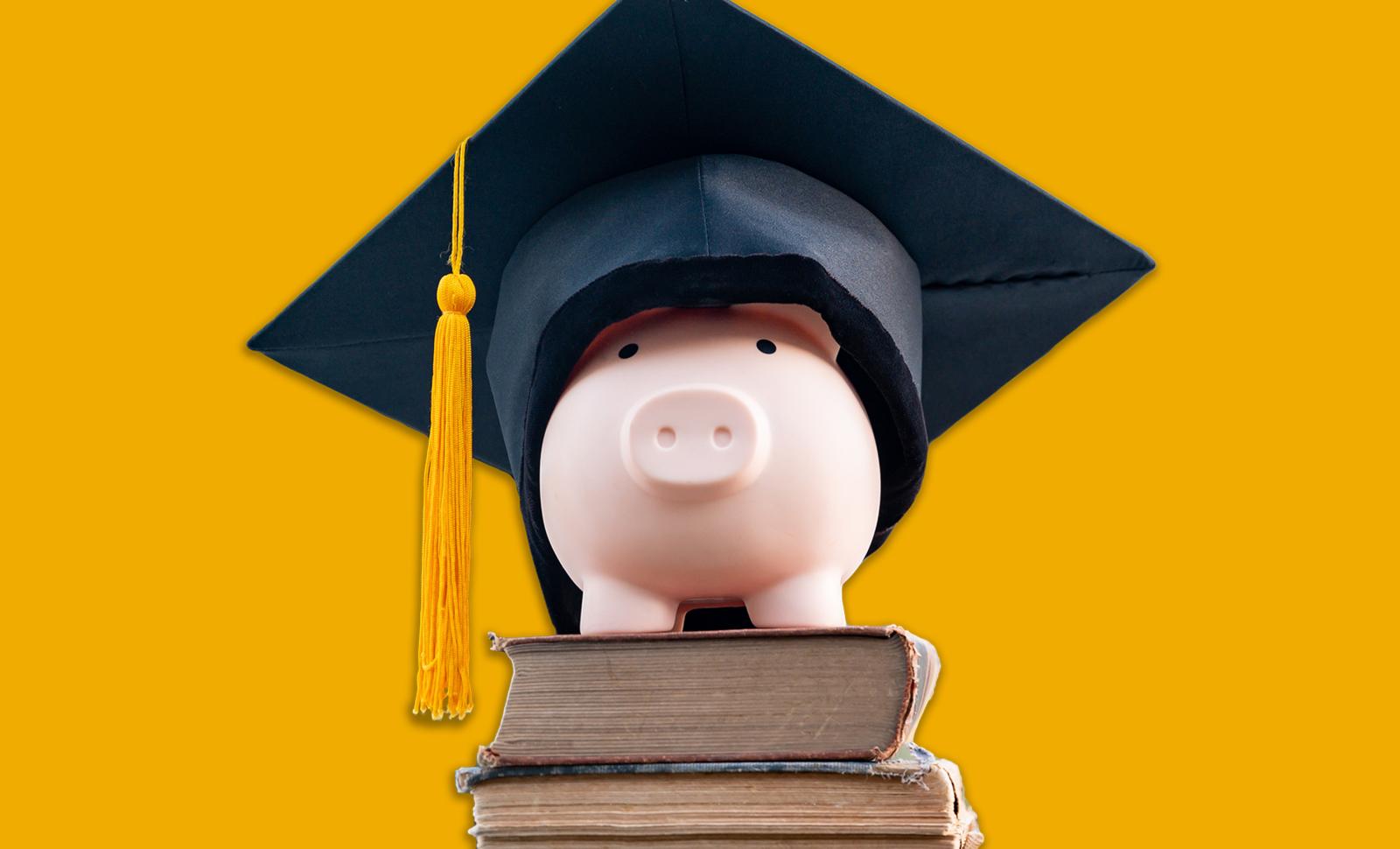 Piggy bank wearing mortar board on top of books